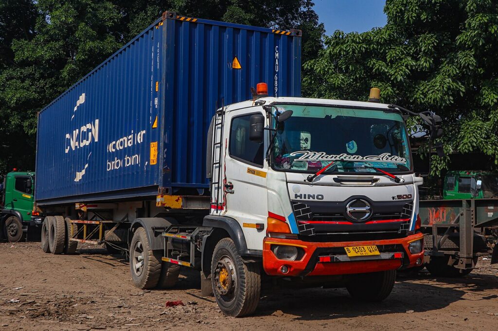 Truk barang melintas di jalan raya di Indonesia